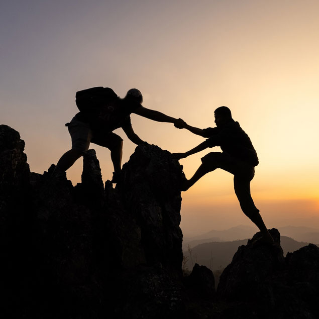 Climber helping another climber up